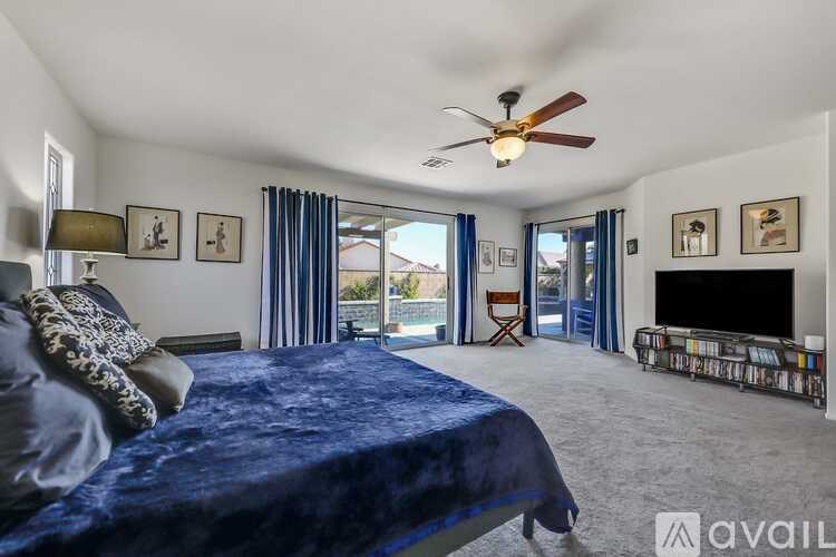 A bedroom with a large bed and a television.