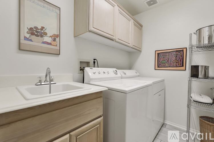 A kitchen with a white sink and a white dishwasher.