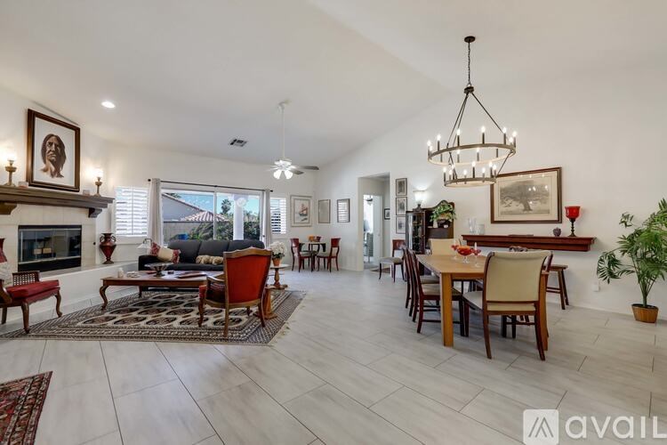 A spacious living room with a fireplace and a dining area.