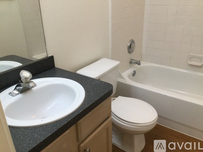 A bathroom with a sink, toilet, and bathtub.