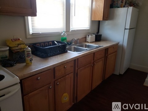 A kitchen with wooden cabinets and a white fridge.