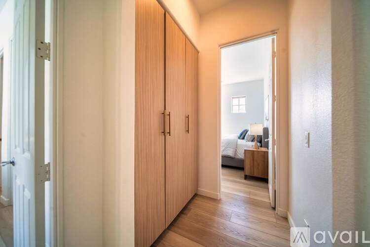 A hallway with a bedroom at the end.