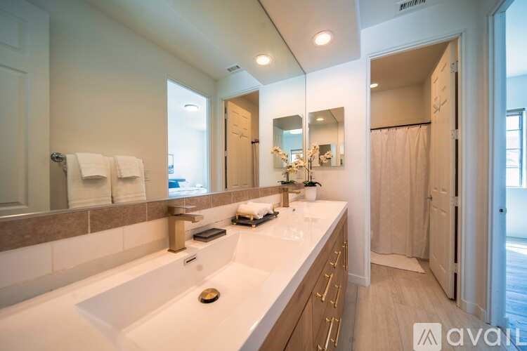 A bathroom with a large sink and a mirror above it.