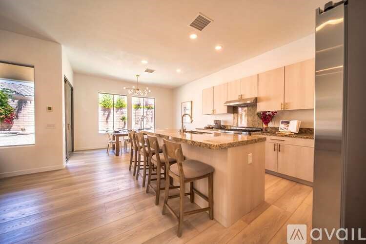 A kitchen with a table and chairs is available for rent.