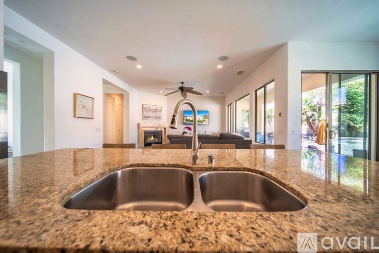 A modern kitchen with a central island and a sink.