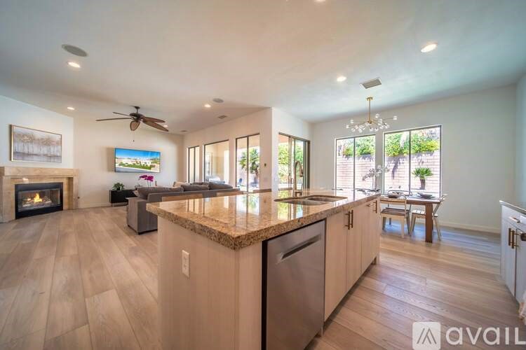 A modern kitchen with a fireplace and a television mounted above it.