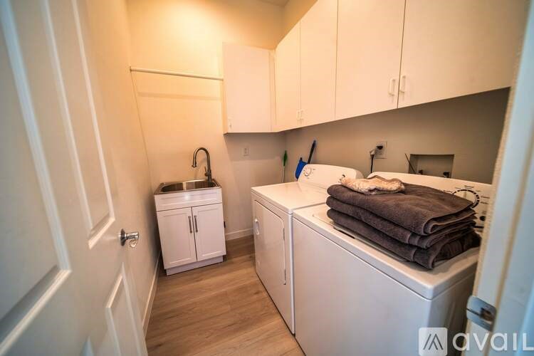 A small laundry room with a washer and dryer.