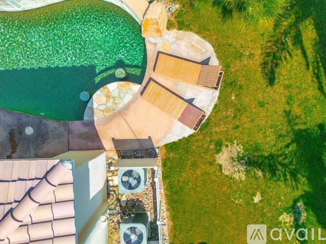 A bird's eye view of a house with a green roof and a brown roof.