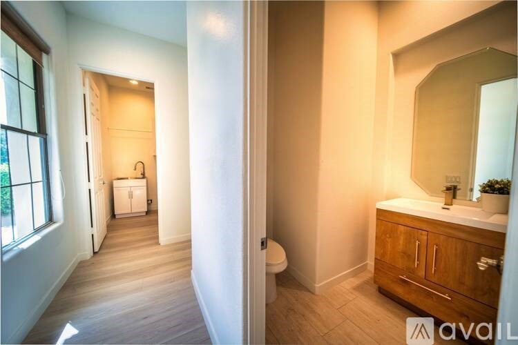 A bathroom with a wooden cabinet and a mirror.