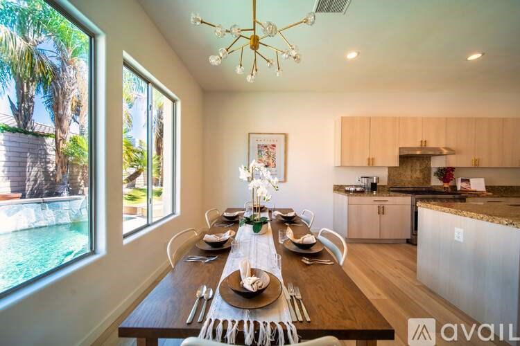 A dining room with a wooden table set for a meal.