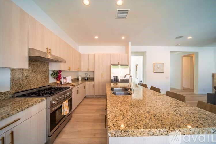 A kitchen with granite countertops and stainless steel appliances.