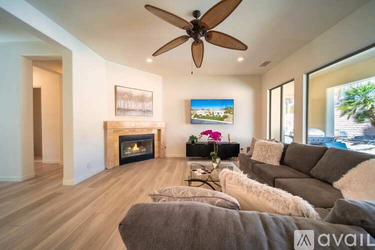 A living room with a fireplace and a painting on the wall.