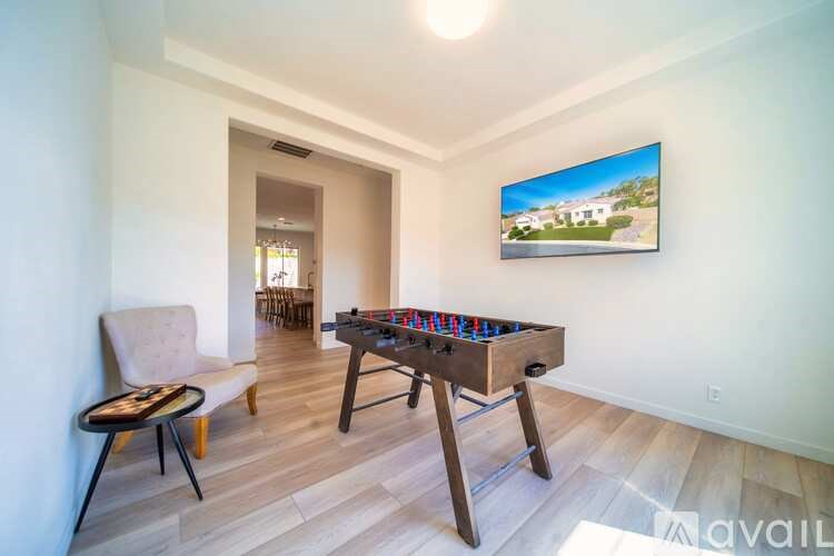 A room with a pool table and a chair.