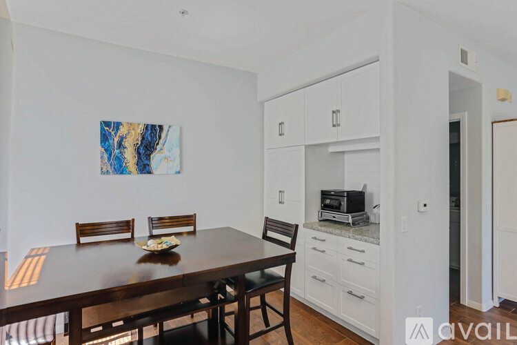 A dining room with a wooden table and chairs.
