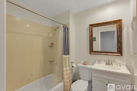 A bathroom with a toilet, sink, and shower.