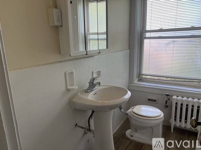 A spacious office with a concrete floor and walls, furnished with a desk, chairs, and cabinets.