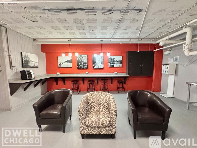 A room with a red wall and a couch.