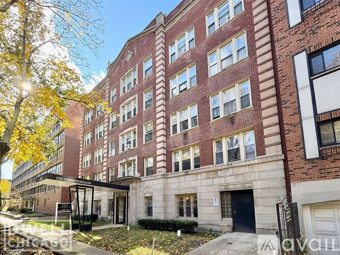 A red brick building with a black door and windows.