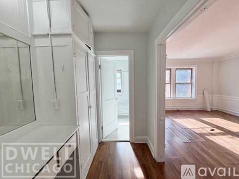 A kitchen with a black refrigerator, stainless steel oven, and wooden cabinets.