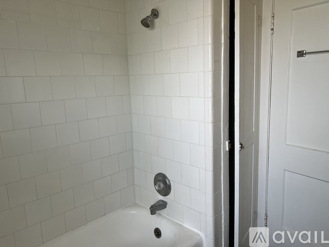 A spacious hallway with tiled floors and a black and white striped wall.