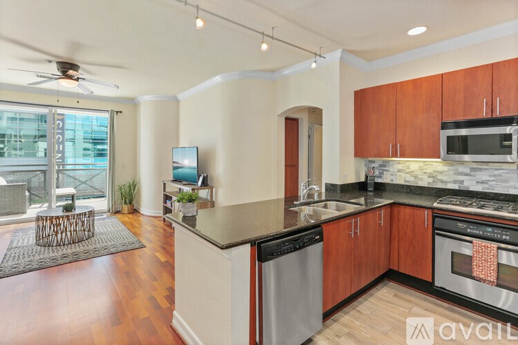 A kitchen with wooden cabinets and a black countertop.