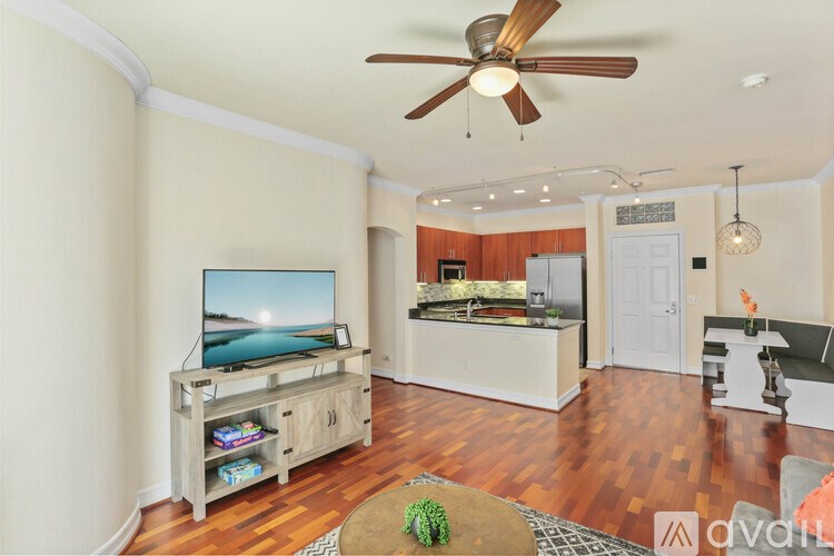 A living room with a television and a wooden cabinet.