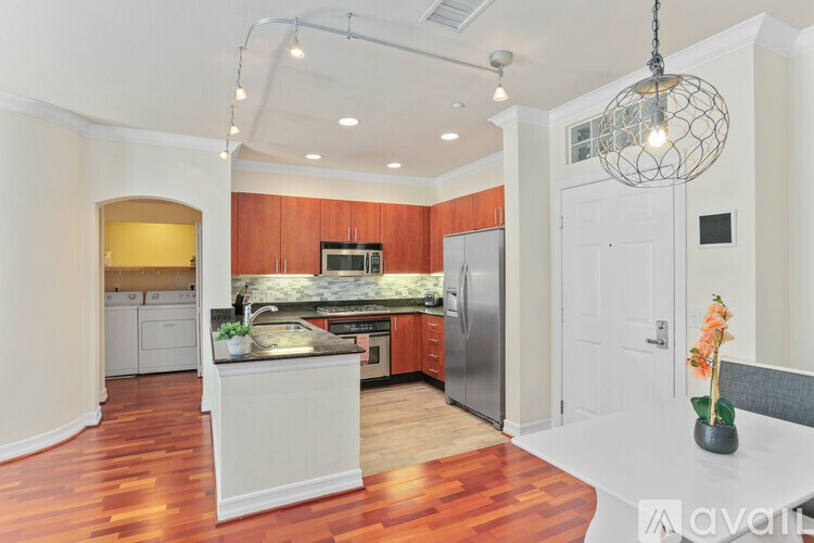 A kitchen with wooden floors and a white island.