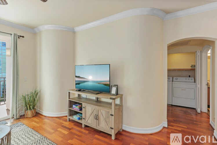 A living room with a television and a wooden cabinet.