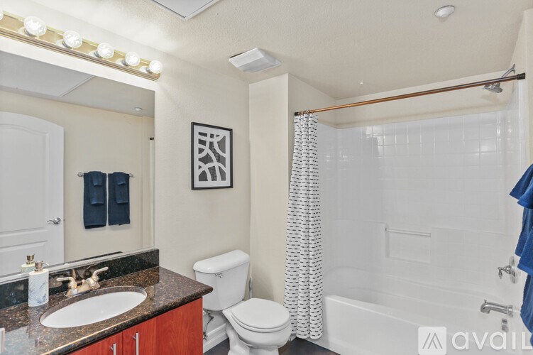 A bathroom with a toilet, sink, and shower.