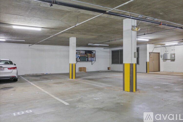 A parking garage with a white car parked in spot 109.