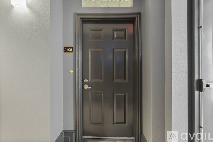 A dark brown door with a gold handle and a number 1408 above it.