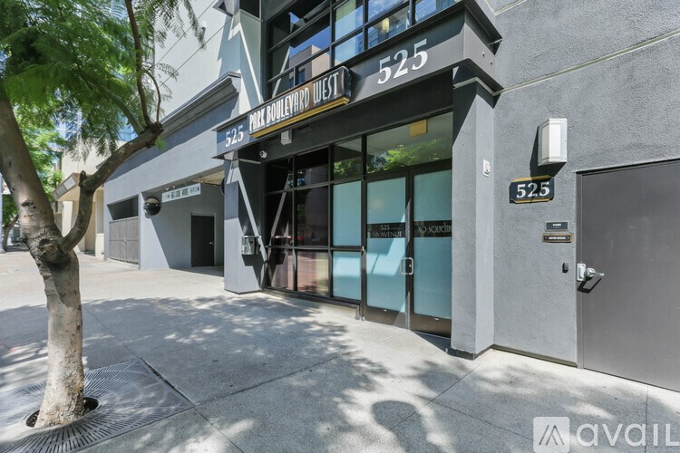 The image shows the front of a building with the number 525 and the words "HOLLYWOOD WEST" on it.