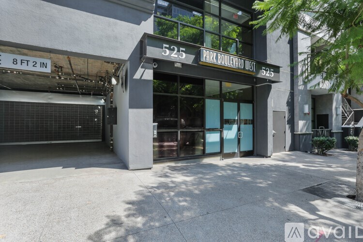 The image shows a building entrance with a sign that reads "525 PARK BOULEVARD WEST 323".