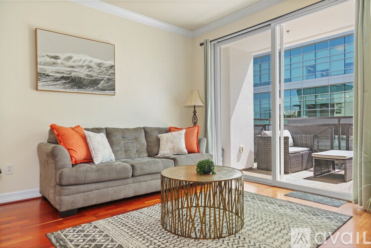 A living room with a grey couch and a wooden coffee table.