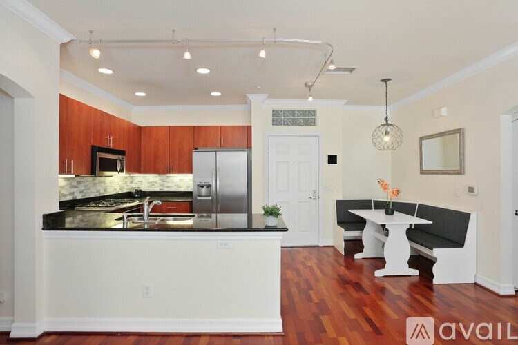 A kitchen with wooden cabinets and a white island.