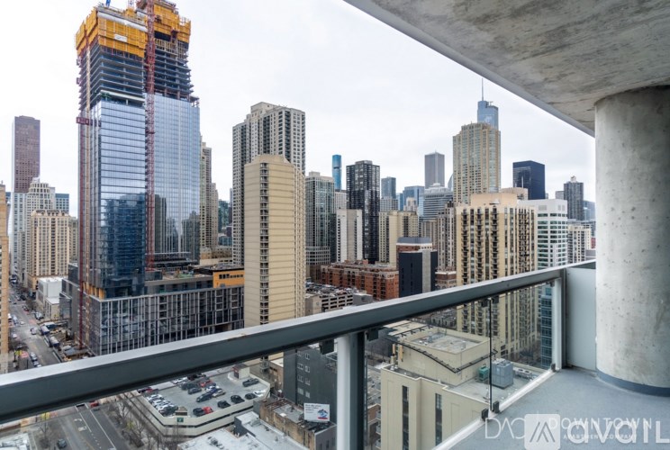 A cityscape with a building under construction in the foreground.