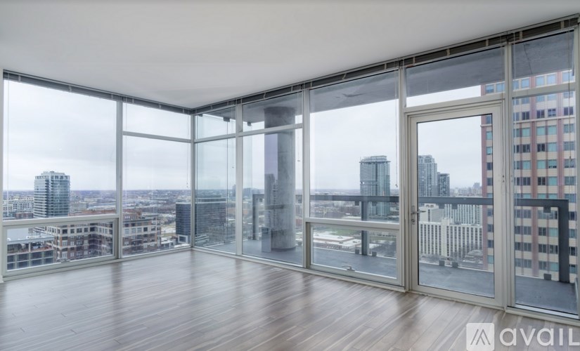 A large empty room with a view of the cityscape outside.