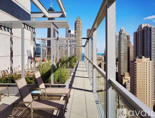 A balcony with chairs and plants overlooking a city skyline.