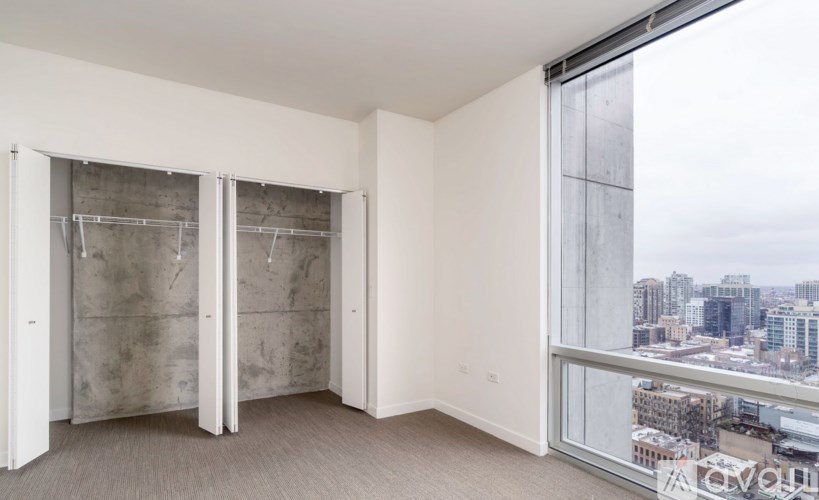 A room with a view of the cityscape outside the window.