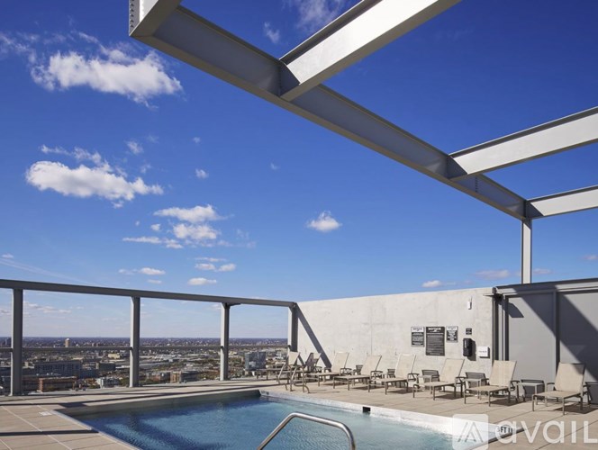 A rooftop pool area with a view of the city.
