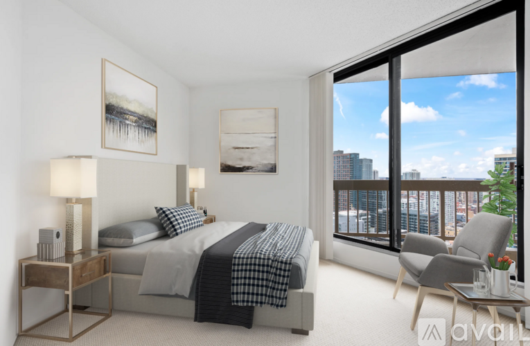 A bedroom with two beds and a balcony overlooking the city.