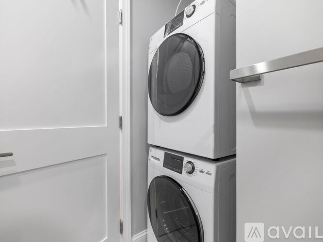 A stack of two washing machines in a laundry room.