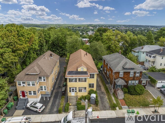 A bird's eye view of a residential area with houses and cars.