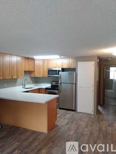 A kitchen with wooden cabinets and a white countertop.