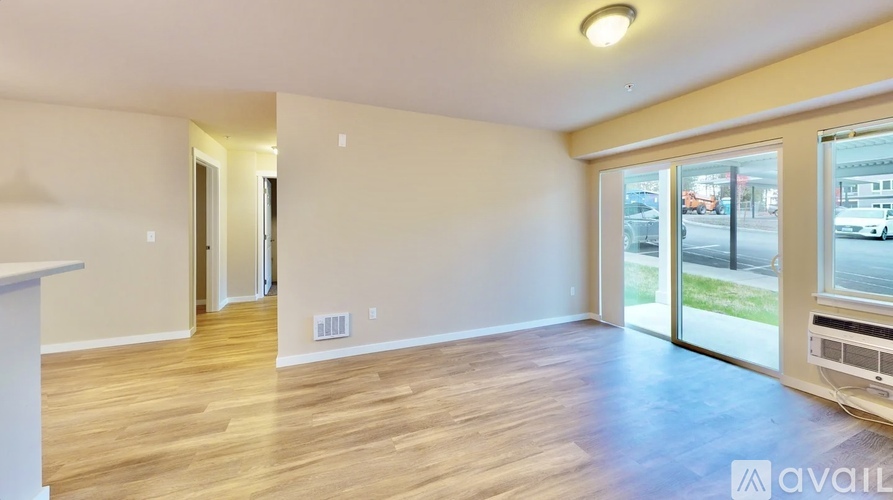 A spacious room with carpeted floor and two doors.