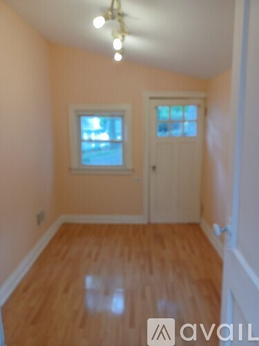 A room with wooden floors and a white door.