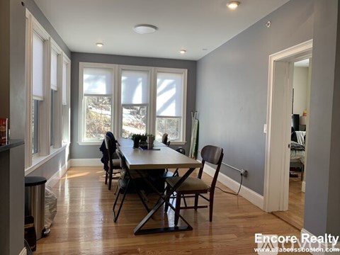 A dining room with a table and chairs is shown.
