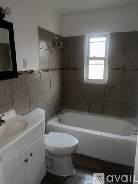 A bathroom with a toilet, sink, and bathtub.