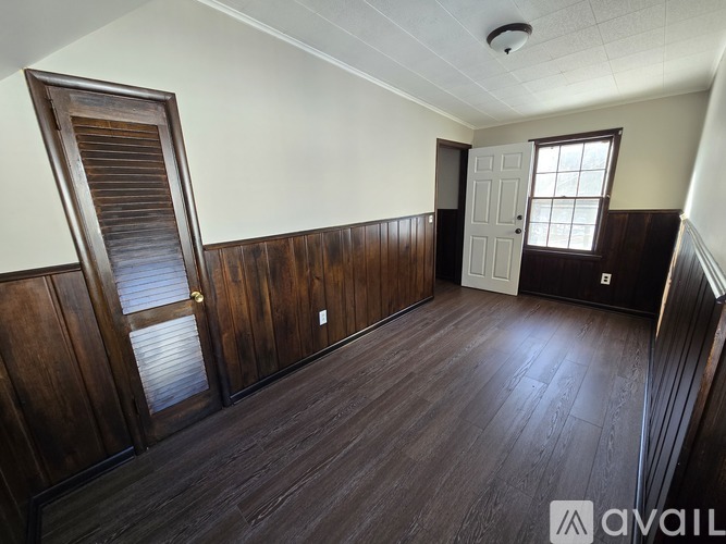 A room with wooden floors and a white ceiling.