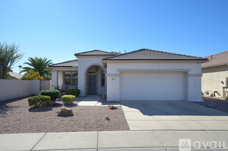 A house with a white garage door is for sale.